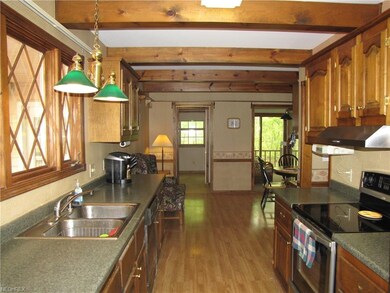 Welcome to the large kitchen with plenty of counter space to work with warm rich tones and easy access to the garage and first floor laundry.