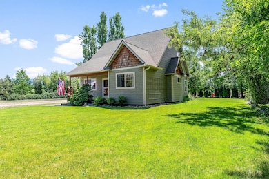 Craftsman-style home with a front lawn and roof with shingles