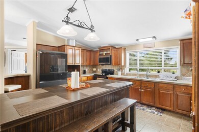 Kitchen featuring crown molding, tasteful backspla