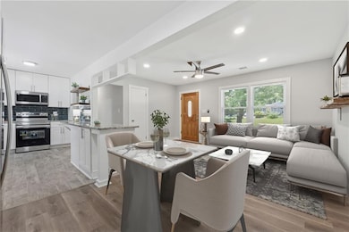 Dining space with ceiling fan, light wood-style flooring, and recessed lighting