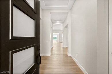 Hallway featuring light wood-type flooring, basebo