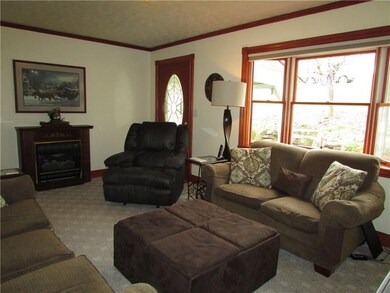 Large livingroom area with gas log fireplace. Bay 