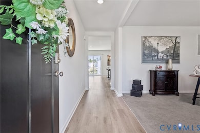 Hall with baseboards and light wood finished floors