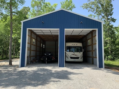 The Storage Barn is 30x50 with all the perks. Two 13-foot-tall overhead doors feature commercial-grade automatic openers for a smooth opening and closing process. It was built to hold a 32' motorhome, a 22' pontoon, trailers, and other toys.