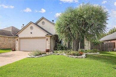 View of front of home with a garage and a front la