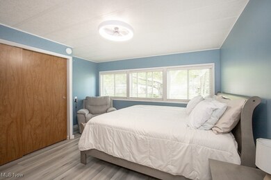 Bedroom featuring wood finished floors and a closet