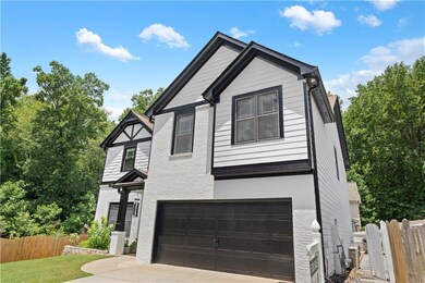 View of front of house with an attached garage and driveway