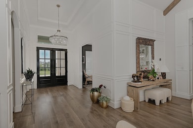Custom mouldings and curated lighting add elegance