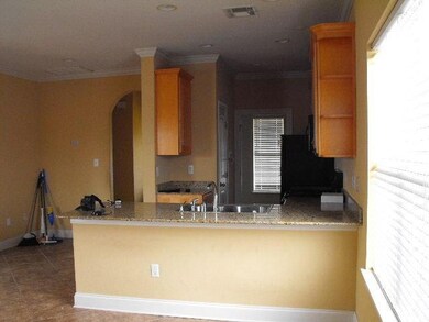 Kitchen with granite tops, dishwasher, range, and refrigerator.