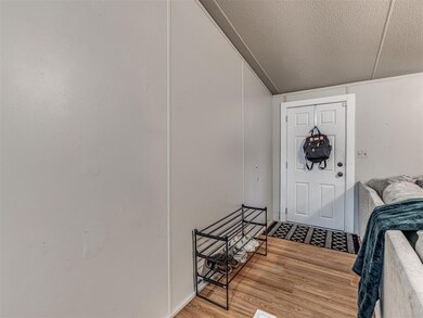 Foyer entrance with wood finished floors and a textured ceiling