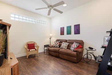 Den with transom lights and hardwood floor
