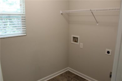 Laundry area with electric dryer hookup and washer hookup