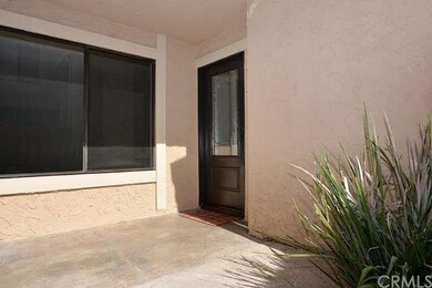 Covered courtyard connecting garage to glass panel