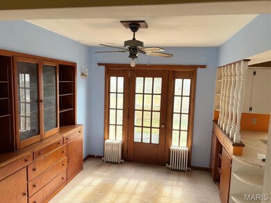 Entryway featuring healthy amount of natural light, radiator, and ceiling fan