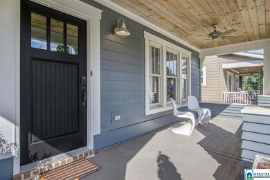 This deep front porch with beautiful wood ceiling 