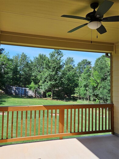 View of patio with fence and ceiling fan