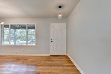 Entrance foyer featuring light wood-style flooring and baseboards