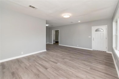 Empty room with wood finished floors and baseboards