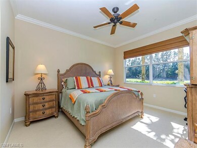Master bedroom with open view of the lake and golf
