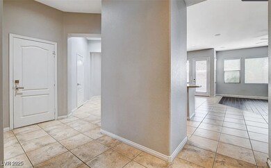 Hall featuring light tile patterned flooring and b