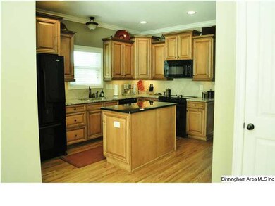 The spacious Kitchen boasts granite countertops, t
