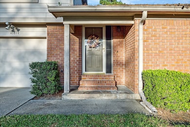 Nicely covered entry with storm door and solar screens for energy efficiency.
