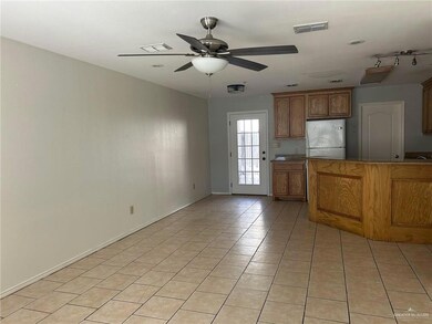 Kitchen featuring visible vents, ceiling fan, light tile patterned floors, and freestanding refrigerator