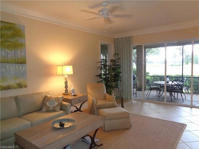 Living room featuring ceiling fan, light tile patt