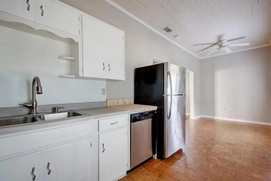 Kitchen featuring visible vents, ceiling fan, whi