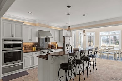 Kitchen with backsplash, wall chimney range hood,