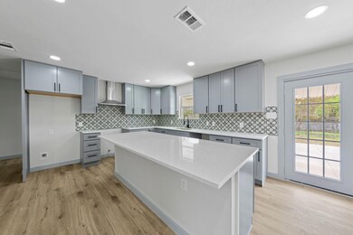Kitchen featuring gray cabinetry, visible vents, w