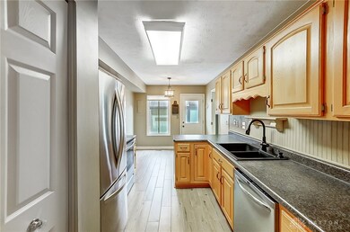 The kitchen is off of the dining room, and quite p