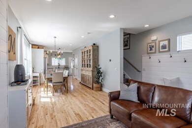 Living room featuring a chandelier, healthy amount of natural light, light wood-style floors, and recessed lighting