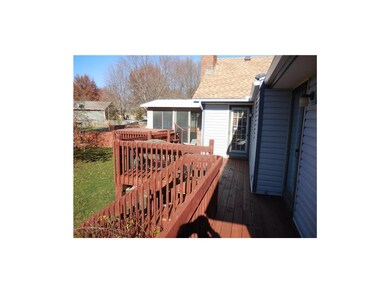 Deck along back of home with doors to Master Bedro