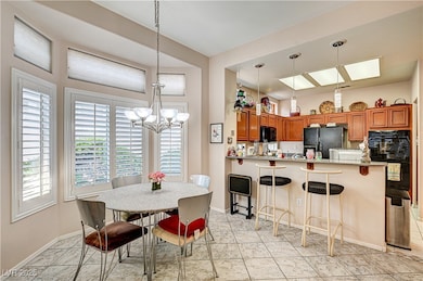 Dining room with a chandelier and baseboards
