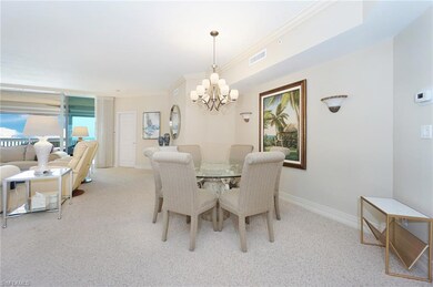 Dining area with crown molding, light colored carp