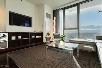 Living room featuring visible vents, a wall of win