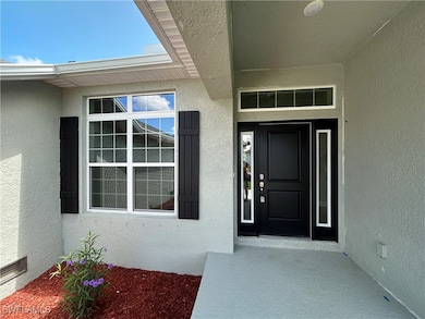 Entrance to property featuring stucco siding