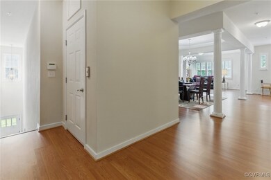 Hall with decorative columns, wood finished floors