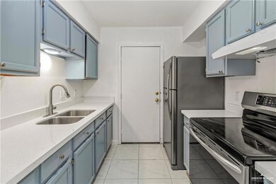 Kitchen featuring sink, stainless steel electric range, and blue cabinets