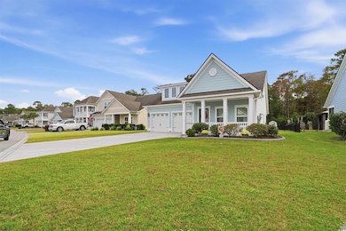 View of front of house with driveway, covered porch, a front lawn, and a residential view