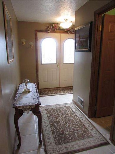Spacious entry with tiled flooring