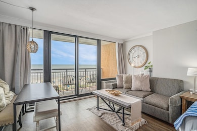 Living room featuring wood finished floors, a water view, crown molding, and an AC wall unit