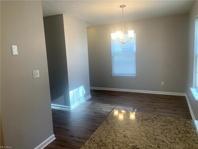 Formal dining room with hardwood floors and natural light