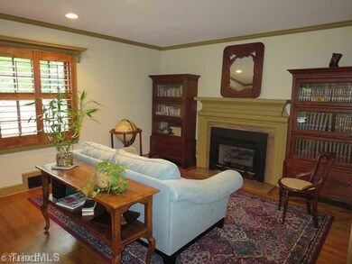 Living Room. Wood Floors, Plantation Shutters, and Gas Fireplace