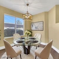 Dining area with wood finished floors, a notable c