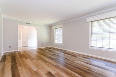 Unfurnished room with light wood-type flooring and ornamental molding