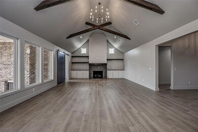 Living room featuring beamed ceiling, a chandelier, light wood-style floors, a Gas Log fireplace, and high vaulted ceiling
