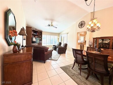 Living room featuring lofted ceiling, ceiling fan
