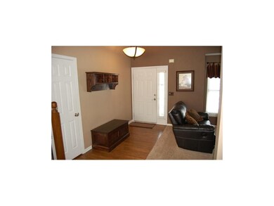 Entry with hardwood floors.